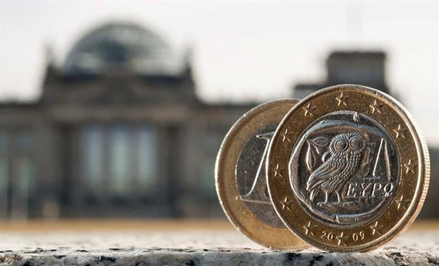 Dos monedas de euro, una de ellas acuñada en Grecia, fotografiadas delante del Bundestag en Berlín (Alemania). EFE/Tim Brakemeier/Archivo