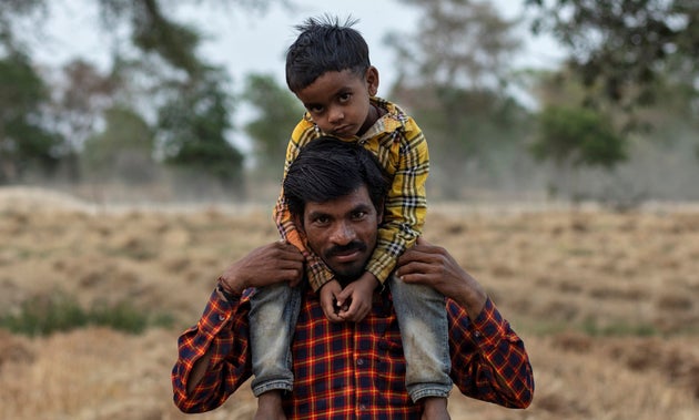 Dayaram Kushwaha, a migrant worker, with his 5-year-old son, Shivam, after he returned to his home from New Delhi to the Jugyai villageMadhya Pradesh, India, April 8, 2020.