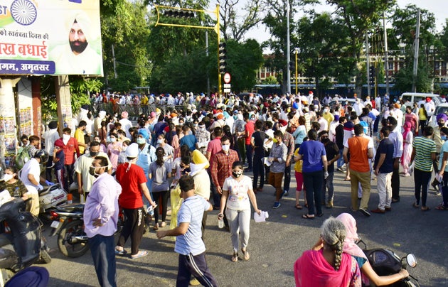 People wait at Shri Ram Ashram Public School for candidates appearing for National Eligibility Cum Entrance Test on September 13, 2020 in Amritsar.