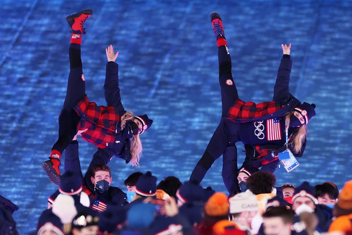 Members of Team USA react as they make their way around the Beijing National Stadium during the Beijing 2022 Winter Olympics closing ceremony.