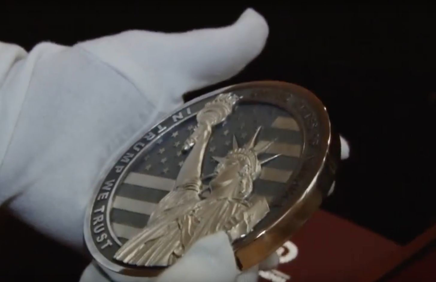 The coin's opposite side features the Statue of Liberty and the engraved line: "In Trump We Trust."