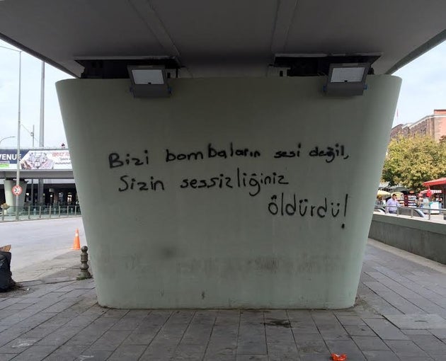 <span class='image-component__caption' itemprop="caption">Graffiti on an Ankara bridge next to a mass anti-government rally reads: "It was your silence that killed us, not the sound of bombs."</span>