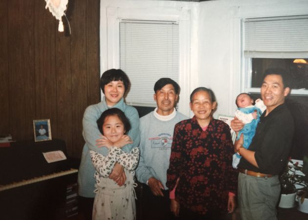 <span class='image-component__caption' itemprop="caption">Li as a child with her parents, grandparents and younger brother, Jeffrey. </span>