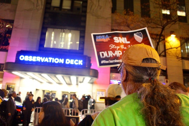 <span class='image-component__caption' itemprop="caption">A protester holds a sign reading "SNL stop the hate" in front of the entrance to NBC headquarters at 30 Rockefeller Center on Wednesday.</span>