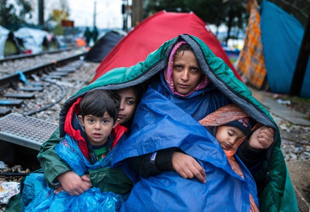 <span class='image-component__caption' itemprop="caption">A woman and her children near the Greece-Macedonia border.</span>