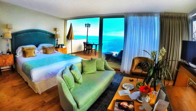 Magnificent view of the Med from the suite terrace, with the orchids given +2 points, and the sliding floor to ceiling windows + 5 points