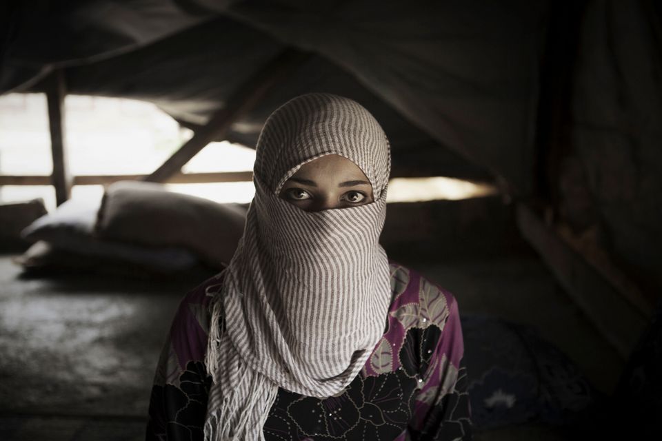 <span class='image-component__caption' itemprop="caption">Syrian refugee Waad, 13, stands inside her tent shelter in Bekaa Valley. Waad, whose father forced her to marry a man she did not know about 8 months ago, now wants a divorce. </span>