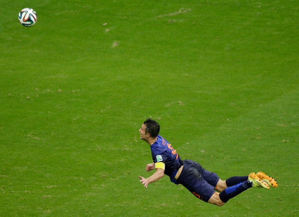 FILE - In this June 13, 2014 file photo, Netherlands' Robin van Persie heads the ball to score during the group B World Cup s