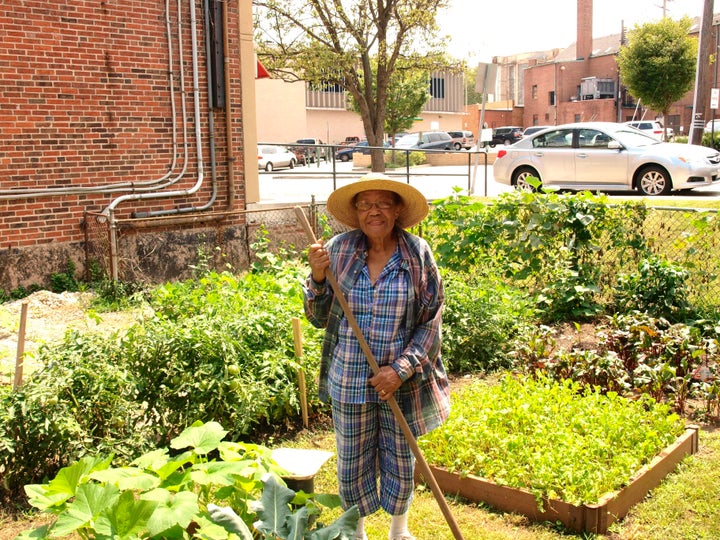 <p>A Pleasant Hope church member tends to the church garden.</p>