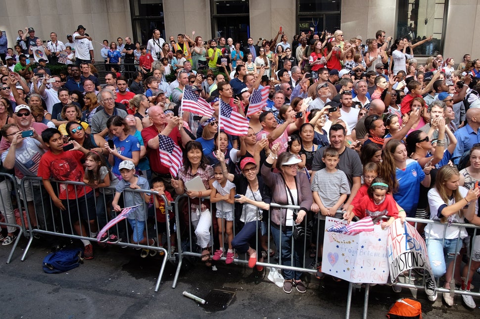 USA women's soccer team fans cheer during the ticker-tape parade in New York on July 10, 2015, to celebrate the team World Cu