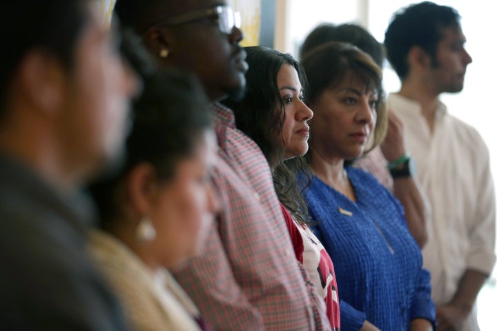 WASHINGTON, DC - MAY 18: Marcia Cruz (C), who was originally from El Salvador, stands with other immigrant workers during a rally May 18, 2015 at the headquarters of AFL-CIO in Washington, DC. Labor leaders were joined by immigrant workers in the rally and vowed to defend President Barack Obamas immigration executive actions. (Photo by Alex Wong/Getty Images)