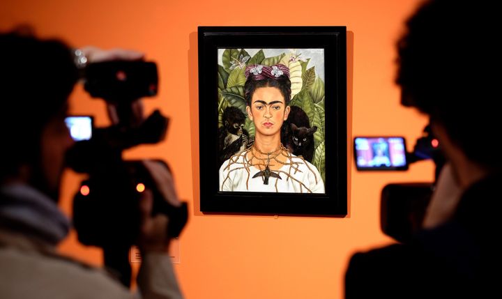 Cameramen film the 'Self-portrait with with Thorn Necklace and Hummingbird' by Mexican artist Frida Kahlo during an exhibition in Rome's Scuderie del Quirinale on March 18, 2014. The Scuderie del Quirinale host a exhibition on the life and work of Mexican artist Frida Kahlo (1907-1954), a symbol of the artistic avant-garde and exuberance of Mexican culture in the 20th century. The exhibition will run from March 20 until August 31, 2014. AFP PHOTO / ALBERTO PIZZOLI RESTRICTED TO EDITORIAL USE, MANDATORY CREDIT OF THE ARTIST, TO ILLUSTRATE THE EVENT AS SPECIFIED IN THE CAPTION (Photo credit should read ALBERTO PIZZOLI/AFP/Getty Images)