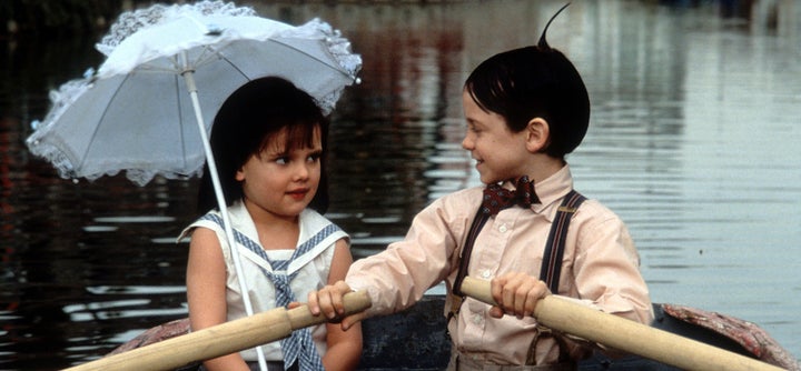 Bug Hall rowing a boat while looking at Brittany Ashton Holmes in a scene from the film 'The Little Rascals', 1994. (Photo by