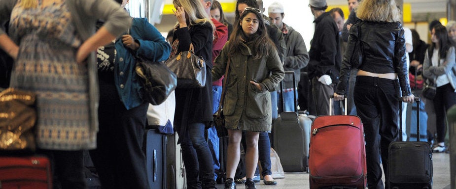 Travellers in a long check-in line caused by a computer malfunction at Spirit Airlines November 24, 2010 at La Guardia Airport in New York on what is considered the heaviest travel day of the year. AFP PHOTO/Stan Honda (Photo credit should read STAN HONDA/AFP/Getty Images)