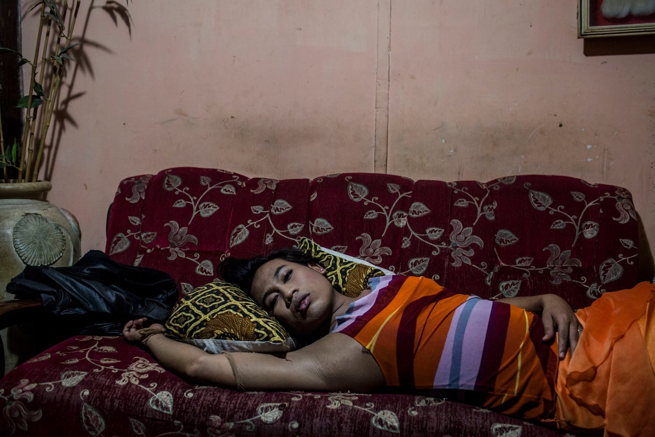 YOGYAKARTA, INDONESIA - JULY 12: Inez, a member of a Pesantren boarding school, Al-Fatah, for transgender people known as 'waria' take a rest as waiting for break the fast during Ramadan on July 12, 2015 in Yogyakarta, Indonesia. During the holy month of Ramadan the 'waria' community gather to break the fast and pray together. 'Waria' is a term derived from the words 'wanita' (woman) and 'pria' (man). The Koran school Al-Fatah was set back last year's by Shinta Ratri at her house as a place for waria to pray, after their first founder Maryani died. The school operates every Sunday. Islam strictly segregates men from women when praying, leaving no-where for 'the third sex' waria to pray before now. (Photo by Ulet Ifansasti/Getty Images)