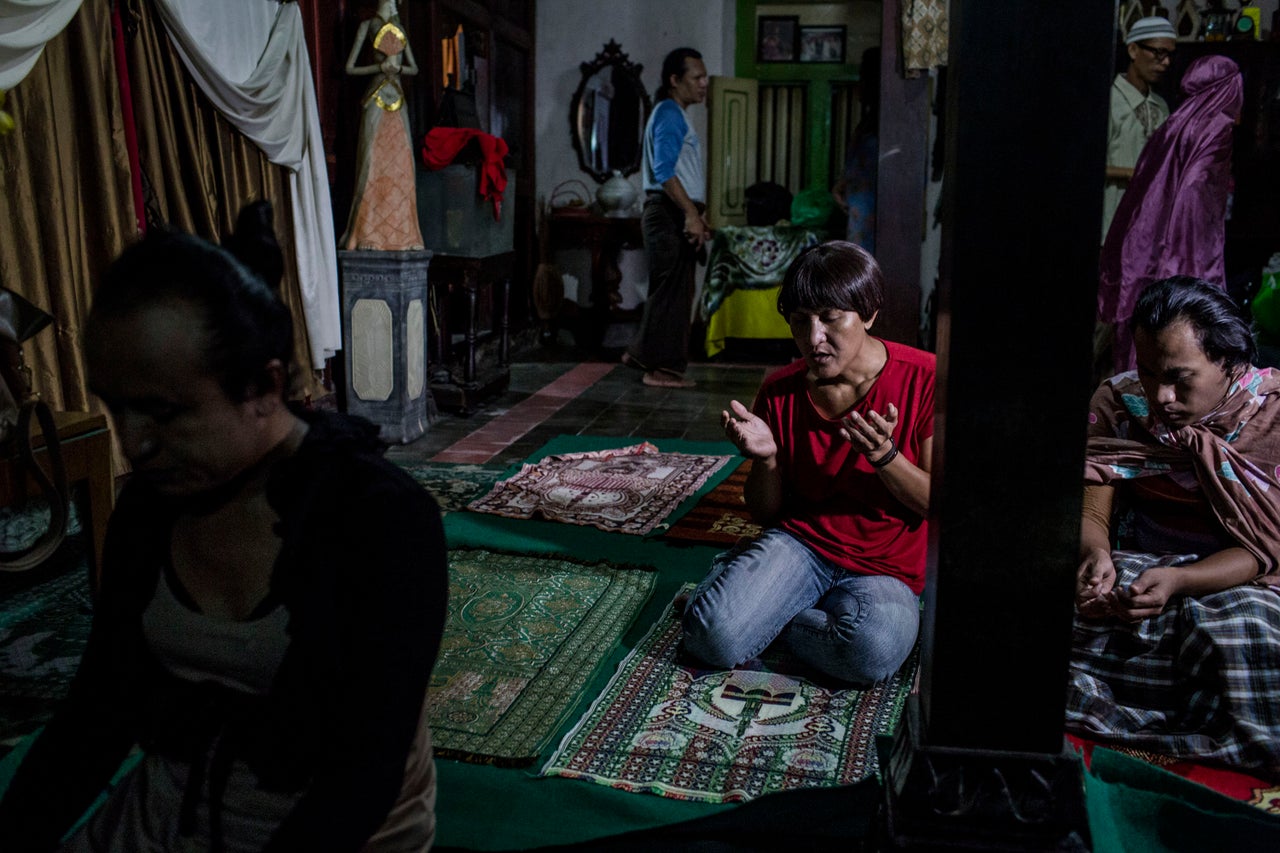 YOGYAKARTA, INDONESIA - JULY 12: Members of a Pesantren boarding school, Al-Fatah, for transgender people known as 'waria' pray during Ramadan on July 12, 2015 in Yogyakarta, Indonesia. During the holy month of Ramadan the 'waria' community gather to break the fast and pray together. 'Waria' is a term derived from the words 'wanita' (woman) and 'pria' (man). The Koran school Al-Fatah was set back last year's by Shinta Ratri at her house as a place for waria to pray, after their first founder Maryani died. The school operates every Sunday. Islam strictly segregates men from women when praying, leaving no-where for 'the third sex' waria to pray before now. (Photo by Ulet Ifansasti/Getty Images)