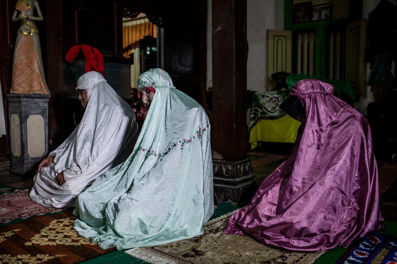 YOGYAKARTA, INDONESIA - JULY 12: Members of boarding school for transgenders known as pesatren 'waria', called Al-Fatah, praying during observe ramadan on July 12, 2015 in Yogyakarta, Indonesia. During the holy month of Ramadan the 'waria' community do activities gather to break the fast and pray together. 'Waria' is a term derived from the words 'wanita' (woman) and 'pria' (man). The Koran school Al-Fatah was set back last year's by Shinta Ratri at her house as a place for waria to pray, after their first founder Maryani died. The school operates every sunday. Islam strictly segregates men from women when praying, leaving no-where for 'the third sex' waria to pray before now. (Photo by Ulet Ifansasti/Getty Images)