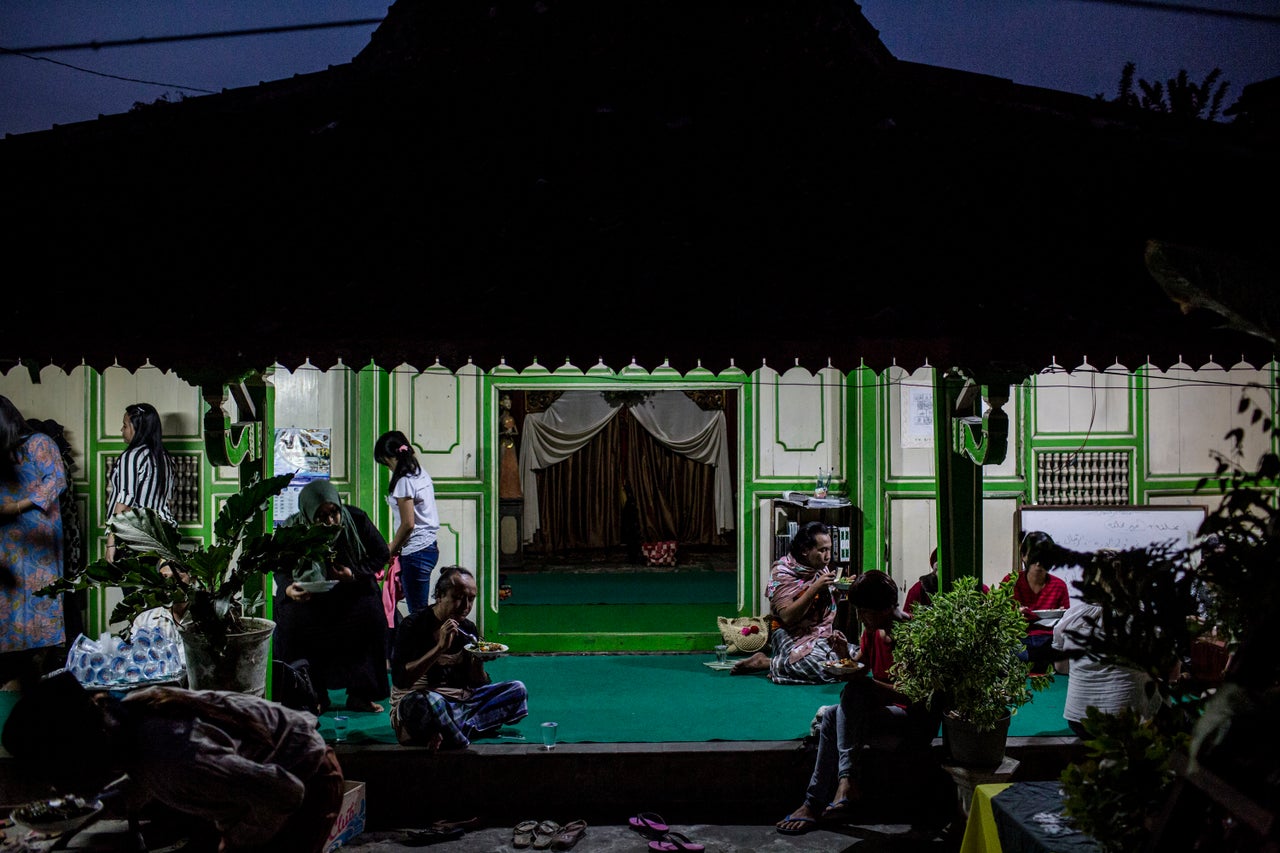 YOGYAKARTA, INDONESIA - JULY 12: Members of a Pesantren boarding school, Al-Fatah, for transgender people known as 'waria' eat as break their fast during Ramadan on July 12, 2015 in Yogyakarta, Indonesia. During the holy month of Ramadan the 'waria' community gather to break the fast and pray together. 'Waria' is a term derived from the words 'wanita' (woman) and 'pria' (man). The Koran school Al-Fatah was set back last year's by Shinta Ratri at her house as a place for waria to pray, after their first founder Maryani died. The school operates every Sunday. Islam strictly segregates men from women when praying, leaving no-where for 'the third sex' waria to pray before now. (Photo by Ulet Ifansasti/Getty Images)