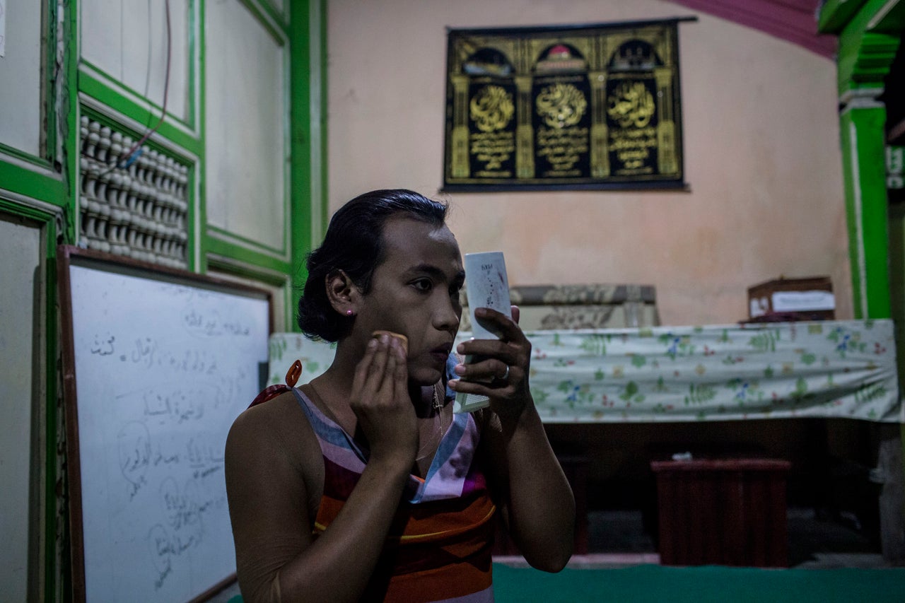 YOGYAKARTA, INDONESIA - JULY 12: Inez, a member of a Pesantren boarding school, Al-Fatah, for transgender people known as 'waria' applies make-up to her face during Ramadan on July 12, 2015 in Yogyakarta, Indonesia. During the holy month of Ramadan the 'waria' community gather to break the fast and pray together. 'Waria' is a term derived from the words 'wanita' (woman) and 'pria' (man). The Koran school Al-Fatah was set back last year's by Shinta Ratri at her house as a place for waria to pray, after their first founder Maryani died. The school operates every Sunday. Islam strictly segregates men from women when praying, leaving no-where for 'the third sex' waria to pray before now. (Photo by Ulet Ifansasti/Getty Images)