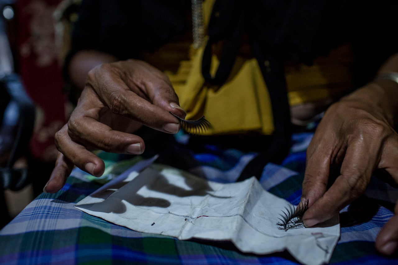 YOGYAKARTA, INDONESIA - JULY 12: Rulli, a member of a Pesantren boarding school, Al-Fatah, for transgender people known as 'waria' holds fake eyelash as clean her face during Ramadan on July 12, 2015 in Yogyakarta, Indonesia. During the holy month of Ramadan the 'waria' community gather to break the fast and pray together. 'Waria' is a term derived from the words 'wanita' (woman) and 'pria' (man). The Koran school Al-Fatah was set back last year's by Shinta Ratri at her house as a place for waria to pray, after their first founder Maryani died. The school operates every Sunday. Islam strictly segregates men from women when praying, leaving no-where for 'the third sex' waria to pray before now. (Photo by Ulet Ifansasti/Getty Images)