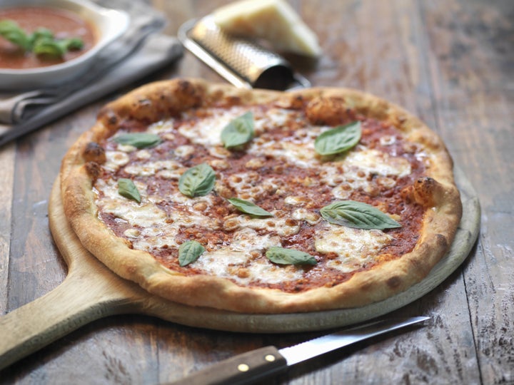 Homemade margherita pizza with mozzarella cheese and fresh basil