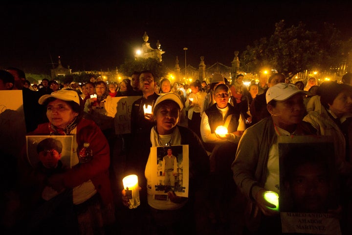 Members of a group of at least 40 Central American women travelling in caravan across Mexico in search of missing migrant relatives stand on the outskirts of the Zapopan Church in Guadalajara, Jalisco State, Mexico, on November 26, 2014. The Caravan of Central American Mothers 2014 will travel to a score of communities in Mexico in search of their beloved ones. AFP PHOTO/Hector Guerrero (Photo credit should read HECTOR GUERRERO/AFP/Getty Images)