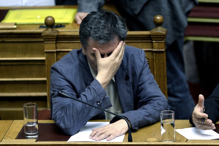 Greek Finance Minister Euclid Tsakalotos gestures as he attends a parliament session in Athens, on July 15, 2015. Greece geared up for a parliamentary vote on draconian reforms demanded by eurozone creditors in exchange for a huge new bailout, just hours after a bombshell report from the International Monetary Fund criticised the deal. AFP PHOTO / ANGELOS TZORTZINIS (Photo credit should read ANGELOS TZORTZINIS/AFP/Getty Images)