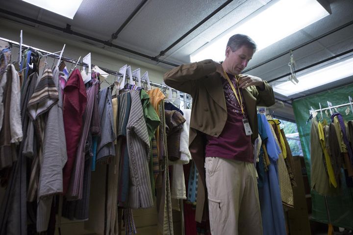 Christian Hancey of Pittsford tries on his coat in the costume room for the Hill Cumorah Pageant on July 9, 2015.
