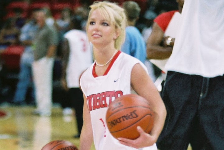 392517 14: Pop singer Britney Spears dribbles a basketball during warmups for NSync''s 'Challenge for the Children III' chari
