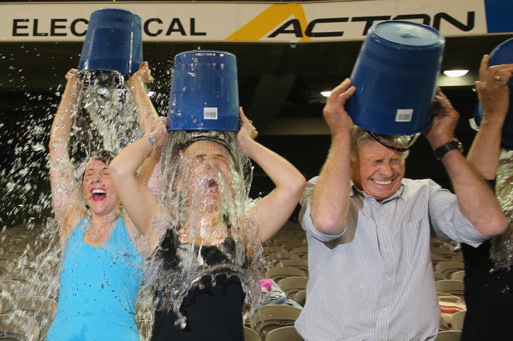 MELBOURNE, AUSTRALIA - AUGUST 22: Participants tip buckets of ice water over their heads as they take part in the World Reco