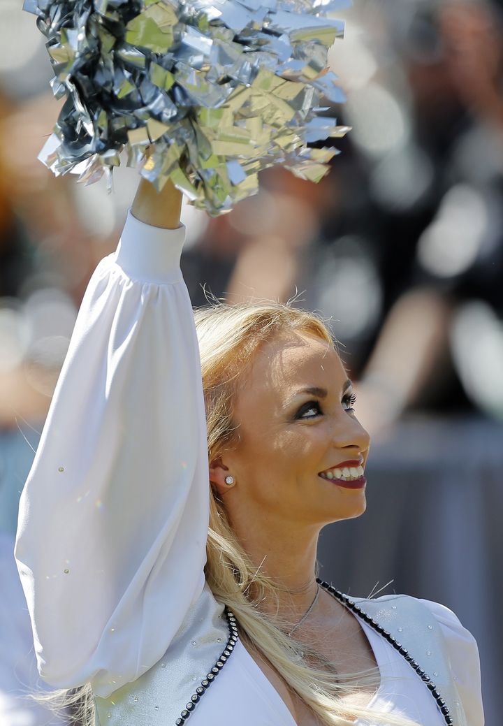 OAKLAND, CA - SEPTEMBER 14: Oakland Raiderette Caitlin Yates, who sued the Oakland Raiders in the offseason, cheers on the team during a game against the Houston Texans on September 14, 2014 at O.co Coliseum in Oakland, California. The Texans won 30-14. (Photo by Brian Bahr/Getty Images)