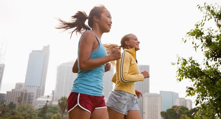 Friends running in urban park