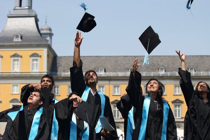 BONN, GERMANY - JULY 04: Students throw up their graduate caps during the 11th celebrations of the Rheinische Friedrich-Wilhelms-Universitaet on July 4, 2015 in Bonn, Germany. This year, 780 women and 293 men finished their studies successfully. (Photo by Andreas Rentz/Getty Images)