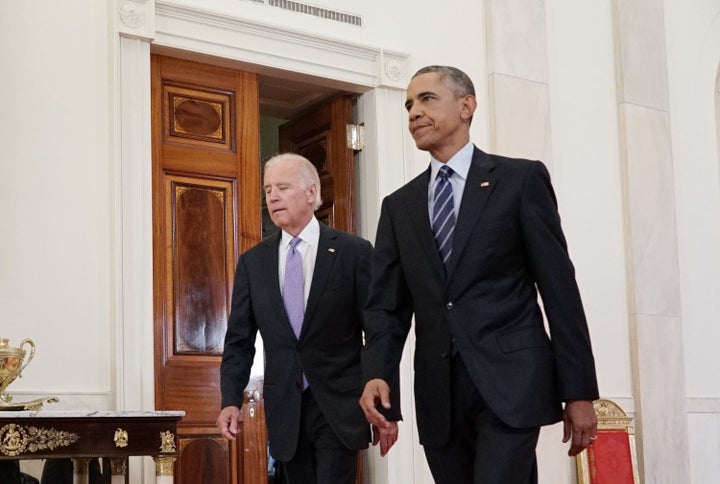US President Barack Obama (R) and Vice President Joe Biden walk from the Green Room to speak on the nuclear deal with Iran on
