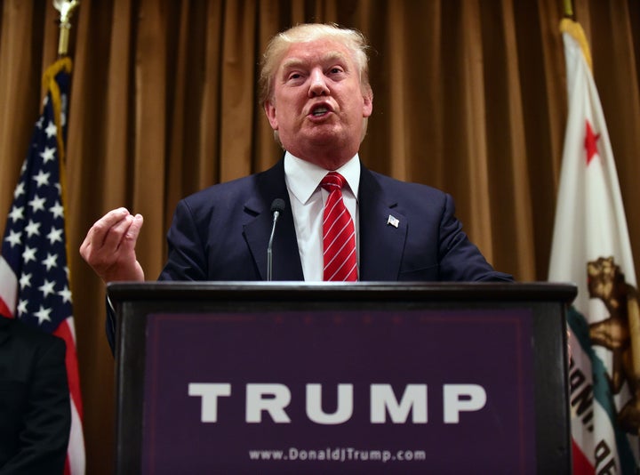 Donald Trump gestures while speaking surrounded by people whose families were victims of illegal immigrants on July 10, 2015 while meeting with the press at the Beverly Wilshire Hotel in Beverly Hills, California, where some shared their stories of the loss of a loved one. The US business magnate Trump, who is running for President in the 2016 presidential elections, angered members of the Latino community with recent comments but says he will win the Latino vote. AFP PHOTO / FREDERIC J. BROWN (Photo credit should read FREDERIC J. BROWN/AFP/Getty Images)