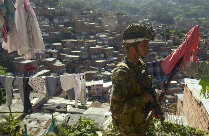 A Colombian soldier patrols the streets at the Comuna 13 shanty town in Medellin, Antioquia department, Colombia on May 24, 2014; a day ahead of Colombia's presidential elections. AFP PHOTO/Raul ARBOLEDA (Photo credit should read RAUL ARBOLEDA/AFP/Getty Images)