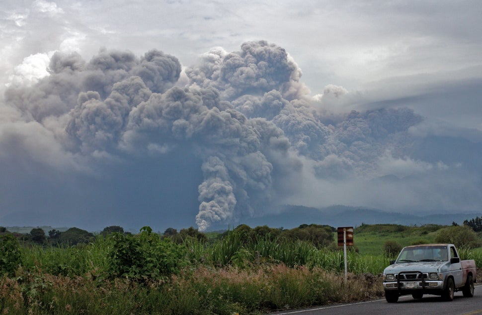 <p>View of the Fire Volcano spewing ash from Tonila community, Jalisco State, Mexico, on July 11, 2015. Western Mexico's Volcano of Fire spewed a four-kilometre column (2.5 miles) of ash and molten rock late Friday, prompting authorities to evacuate 80 people from a small village. The volcano, on the border between the states of Jalisco and Colima, has been active since Thursday but its eruptions intensified on Friday and ash rained down on at least seven communities, according to federal authorities. AFP PHOTO / HECTOR GUERRERO (Photo credit should read HECTOR GUERRERO/AFP/Getty Images)</p>