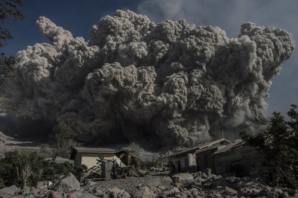 <p>Mount Sinabung volcano spews giant volcanic ash in Karo, North Sumatra on June 25, 2015. Sinabung is one of 129 active volcanoes in Indonesia, which sits on the Pacific Ring of Fire, a belt of seismic activity running around the basin of the Pacific Ocean. AFP PHOTO / SUTANTA ADITYA (Photo credit should read SUTANTA ADITYA/AFP/Getty Images)</p>