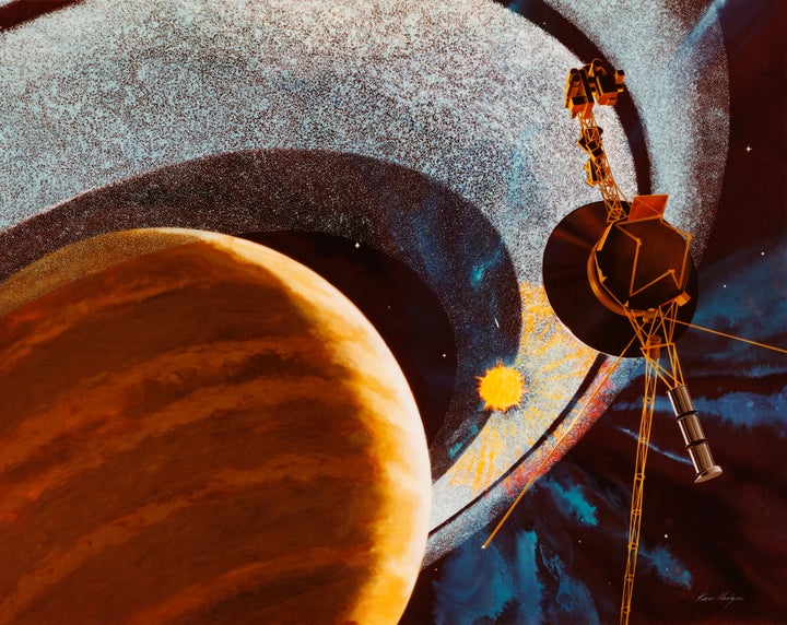 An artist's impression of NASA's Voyager 1 space probe passing behind the rings of Saturn, using cameras and radio equipment