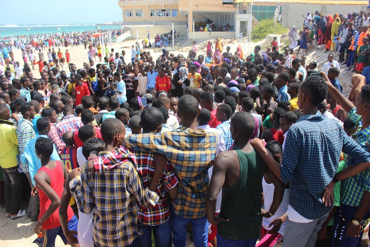 Young men gather to watch an improv dance competition on Eid.