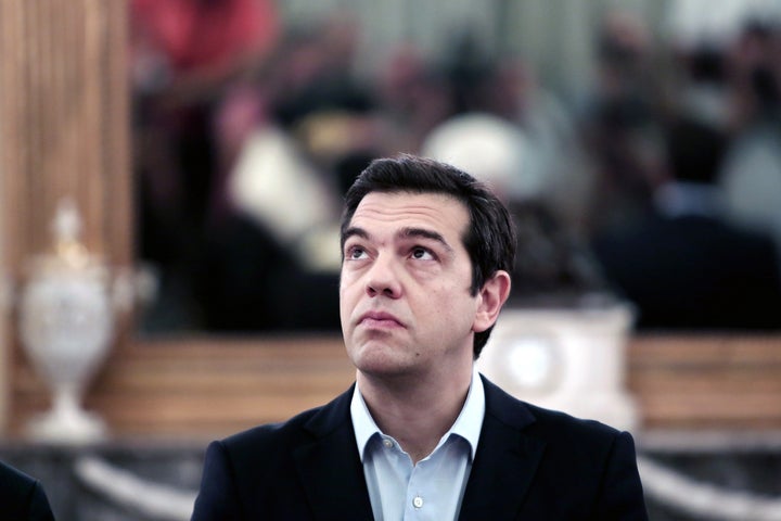 Greek Prime Minister Alexis Tsipras looks up during a swearing-in ceremony of the newly appointed members of the government at the Presidential Palace in Athens on July 18, 2015.