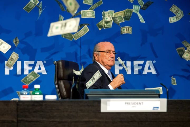 Sepp Blatter was showered with cash by a protester during a FIFA press conference in Zurich on Monday.