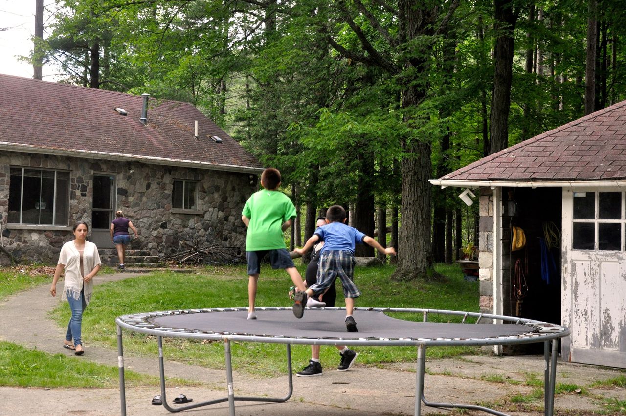Two kids bounce on the trampoline at David Salha's property in Lupton, Michigan.