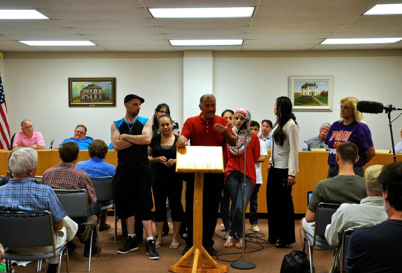 David Salha stands with his family and addresses concerns over his plan to build a summer youth camp on his property at the Ogemaw County Planning Commission meeting in West Branch, Michigan, on June 24, 2015. 