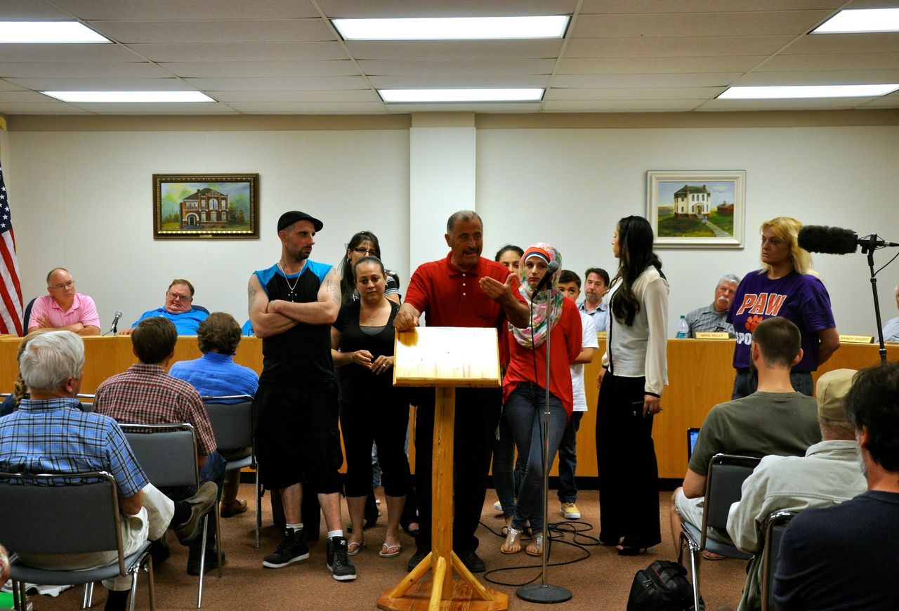 David Salha stands with his family and addresses concerns over his plan to build a summer youth camp on his property at the Ogemaw County Planning Commission meeting in West Branch, Michigan, on June 24, 2015. 