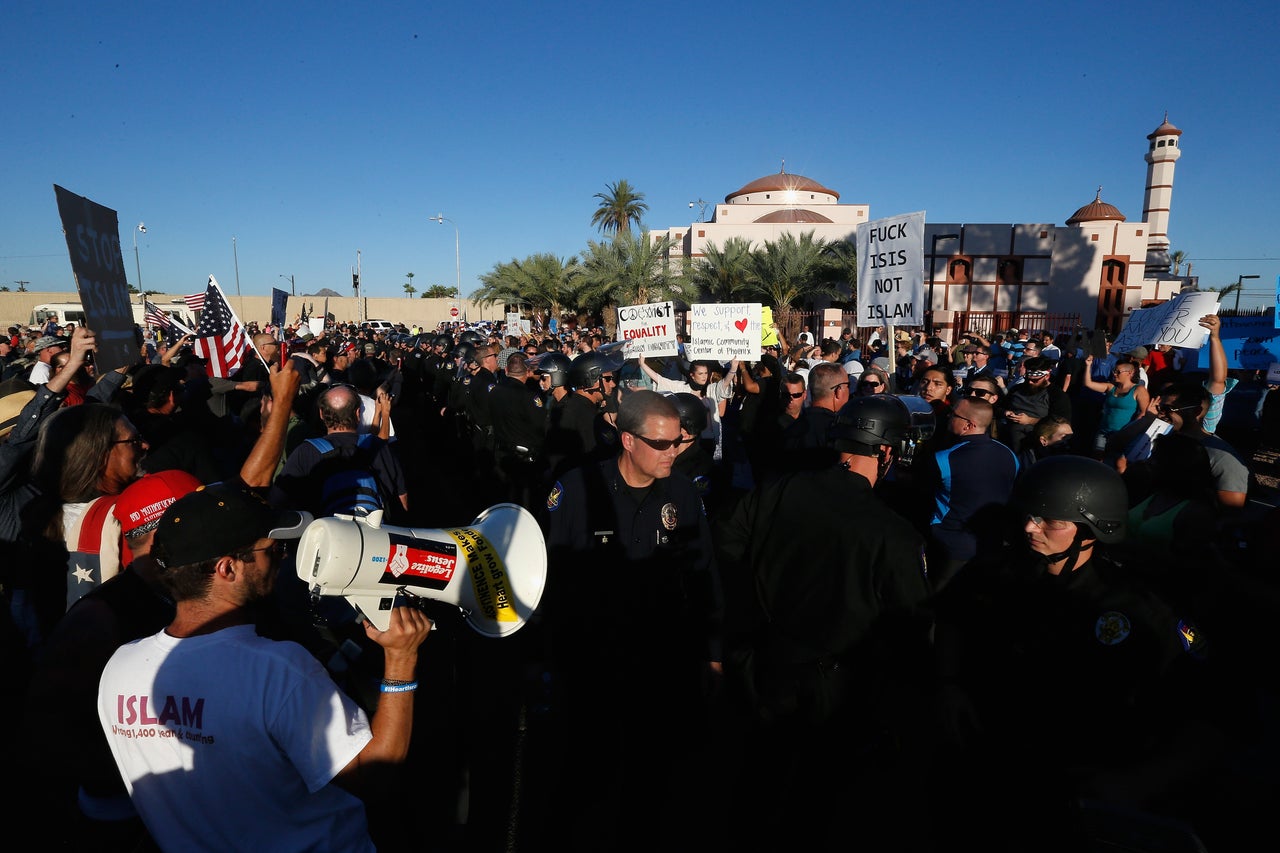 <p>Protesters and counter-protesters rally outside the Islamic Community Center on May 29, 2015 in Phoenix, Arizona. Crowds gathered in response to a planned "freedom of speech" demonstration where attendees were encouraged to bring weapons and "draw Muhammed." </p>