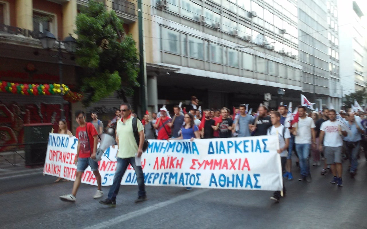 Another PAME banner calls for "raises in salaries and pensions."