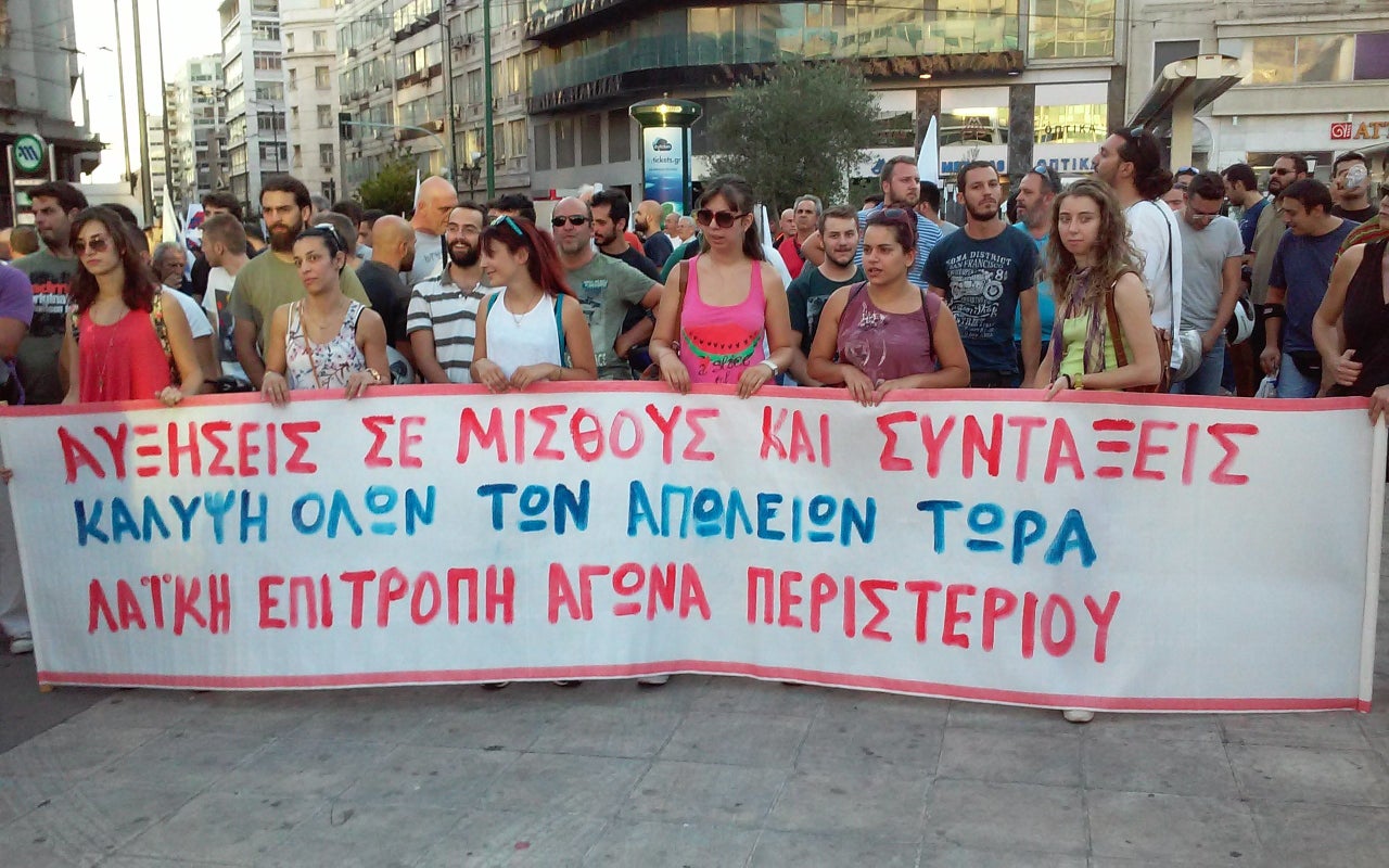 Anti-austerity demonstrators hold a banner as they make their way to Syntagma Square in Athens on July 22, 2015.