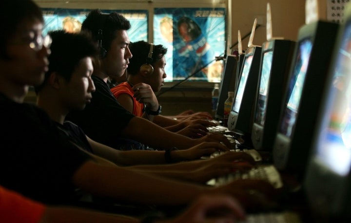 Chinese young people use computers at an Internet cafe in Beijing on Saturday, June 16, 2005.