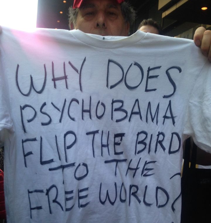 Protester Michael Fandal holds up a T-shirt he made.